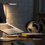 Macbook Pro on Stand Beside Desk Globe